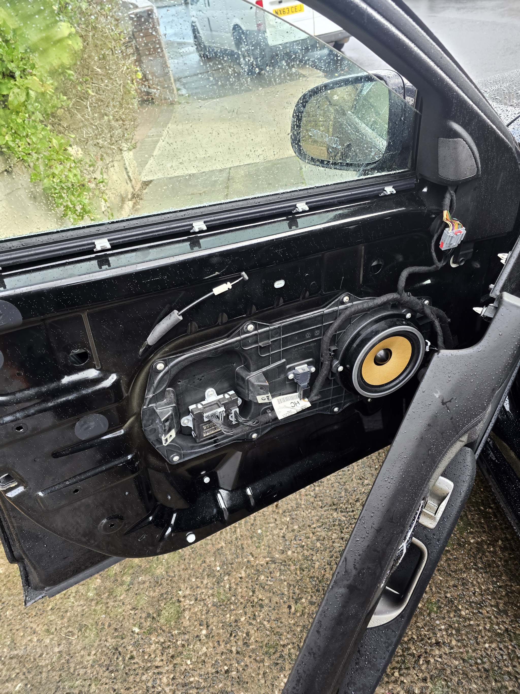 Car door with the door card removed, showing the inside of the door